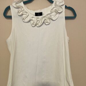 A sleeveless cream shirt